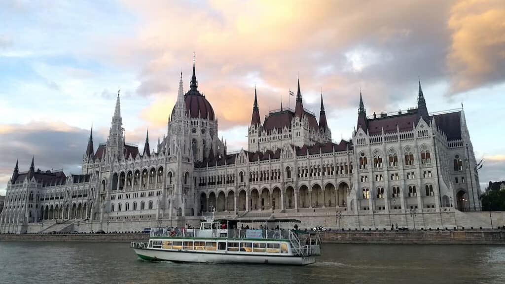 A boat passing by the Budapest Parliament building while cruising along the mighty Danube River.