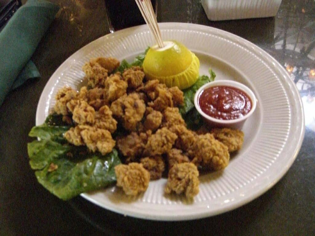 Deep fried bovine testicles known as "rocky mountain oysters" on a plate.