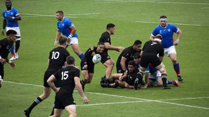 Rugby sport played by two teams wearing red and blue.