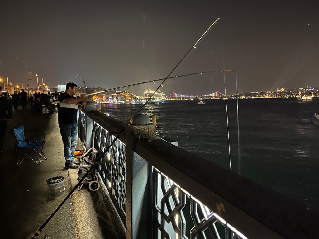 Fishermen on Galata Bridge at night