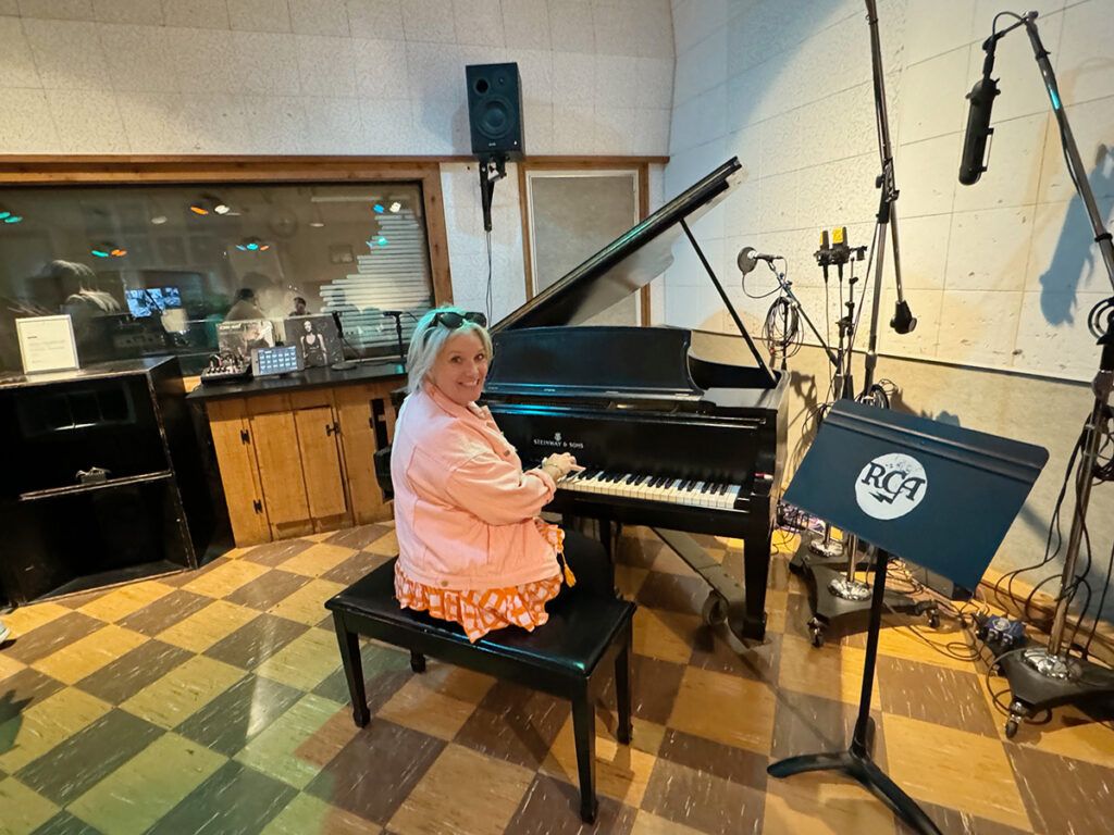 Megan sitting at Elvis Presley's piano in RCA Studio B