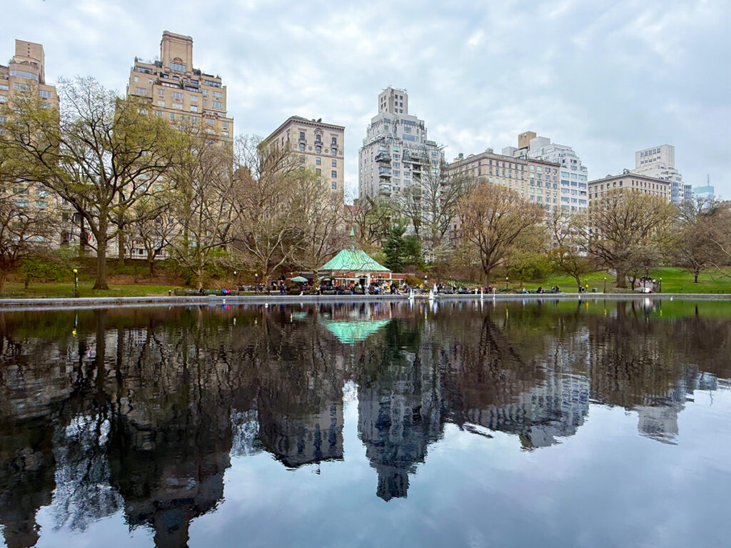 Reflections of the Boat House cafe at Central Park with the lake in front