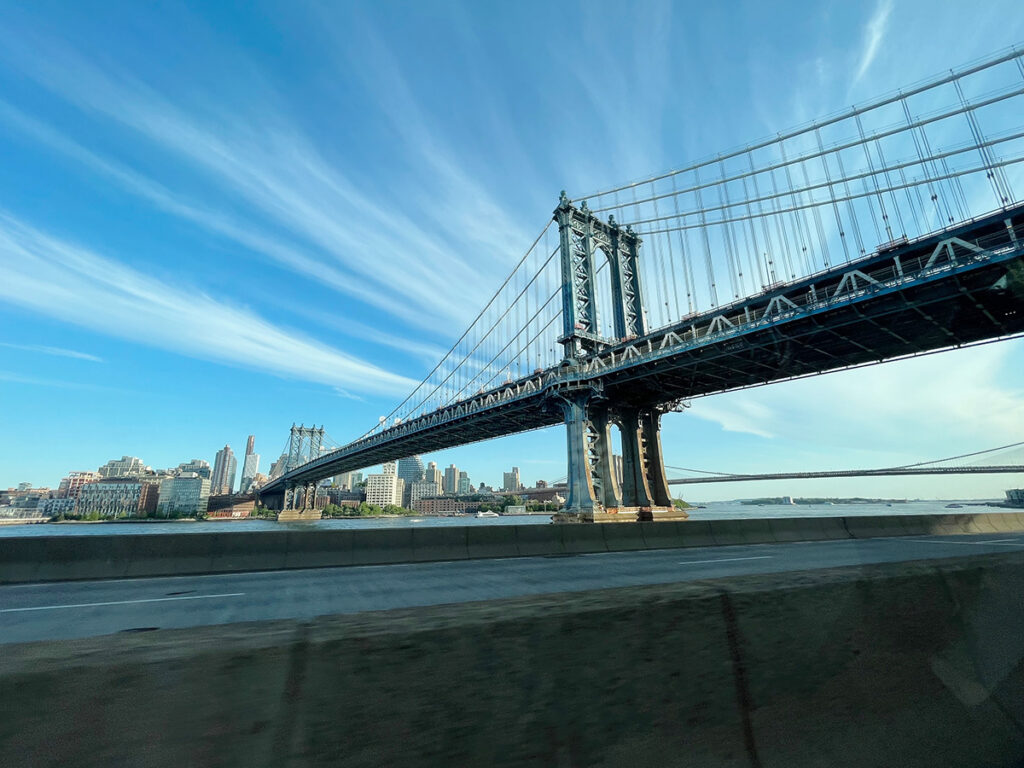 Driving into New York under bridge