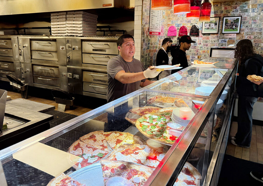 Pizza slices in cabinet at Joe's Pizza