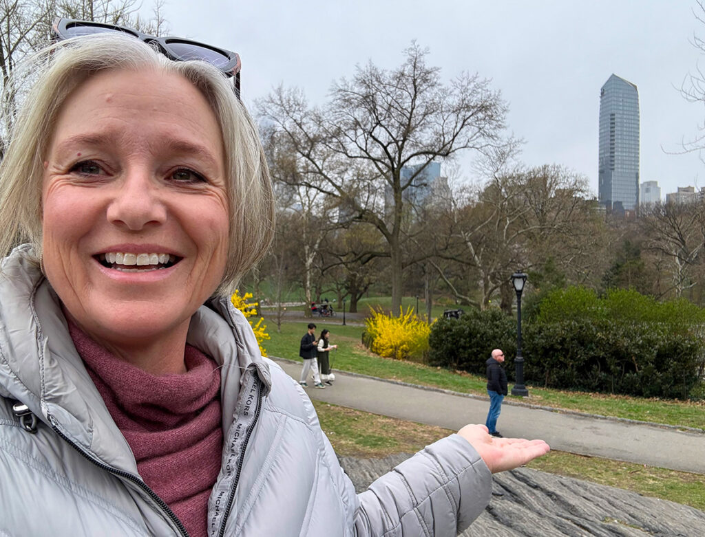 Megan holding her husband in her hand in Central Park