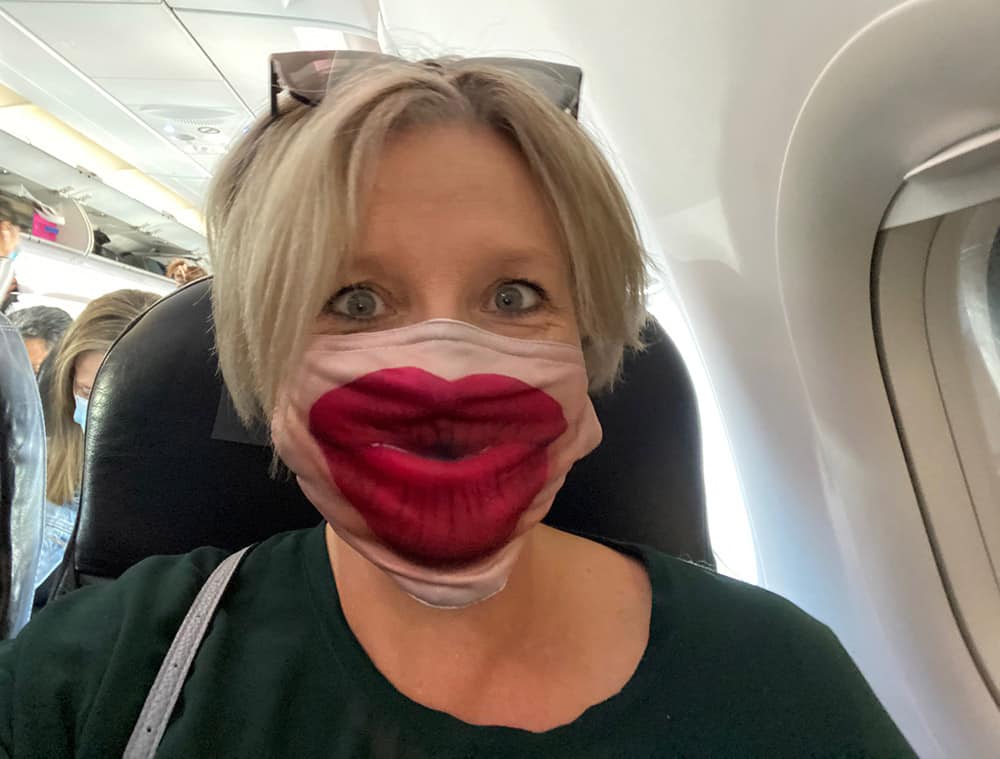 Megan in face mask on a plane