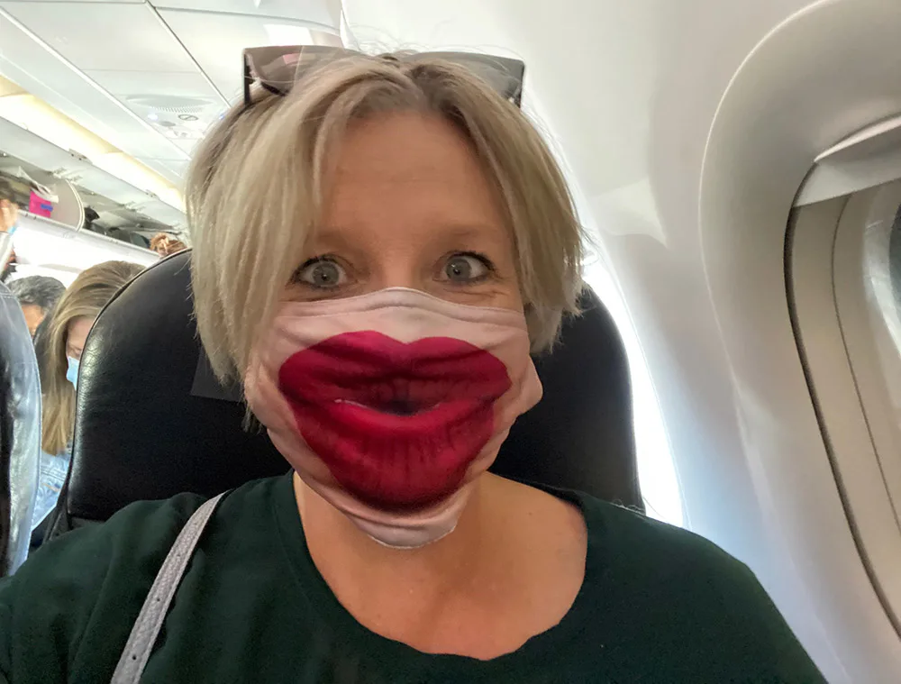Megan in face mask on a plane