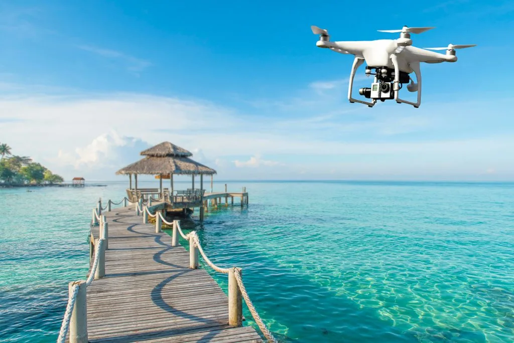 Flying drone over jetty on water