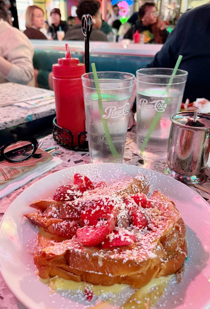 My plate of strawberry waffles dusted in sugar 