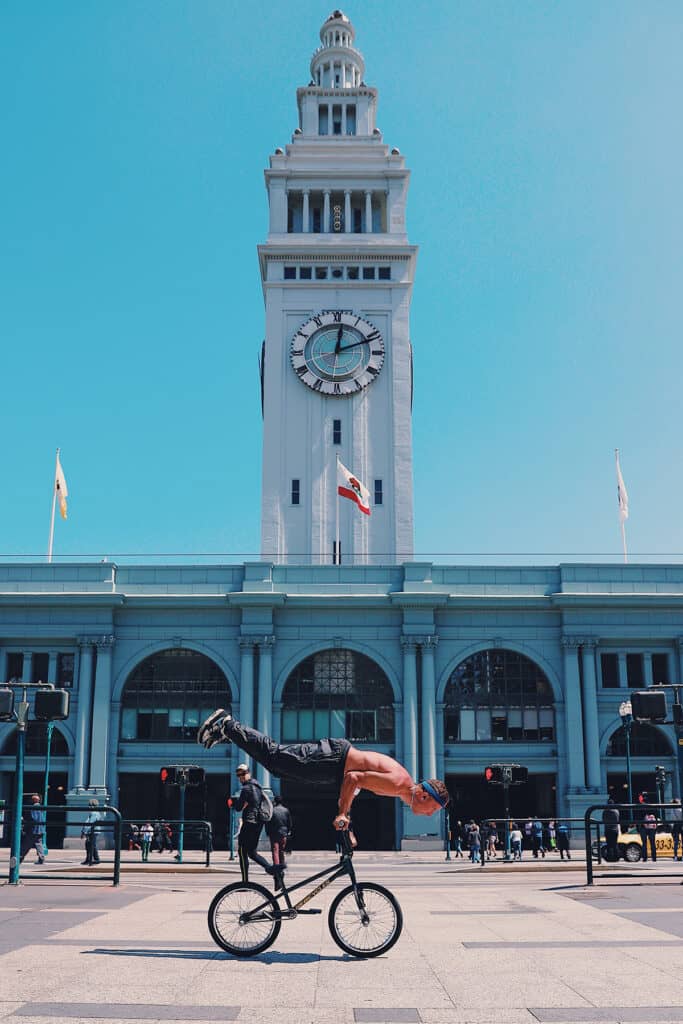 Guy on bike in front of Embarcadero SF