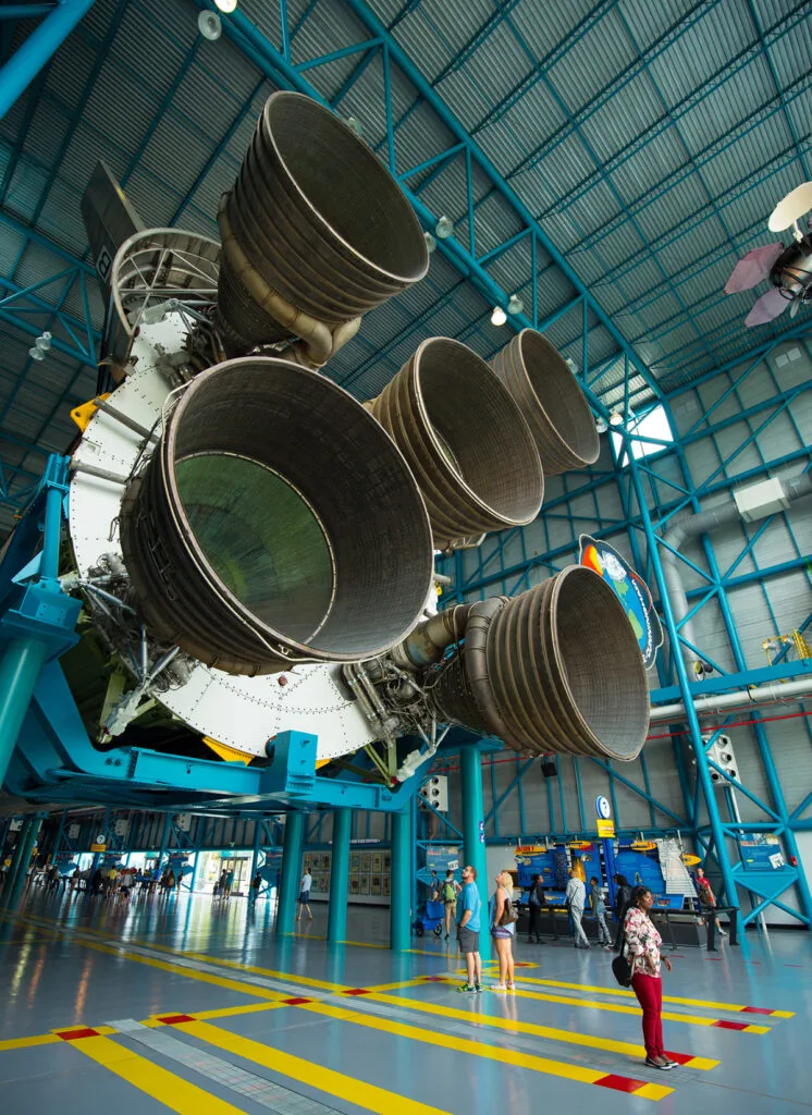 Person standing by rocket at Kennedy Space Center