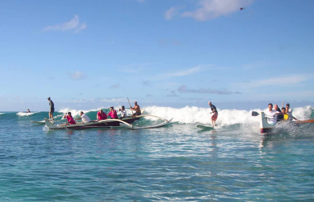Surfing the waves in an outrigger canoe