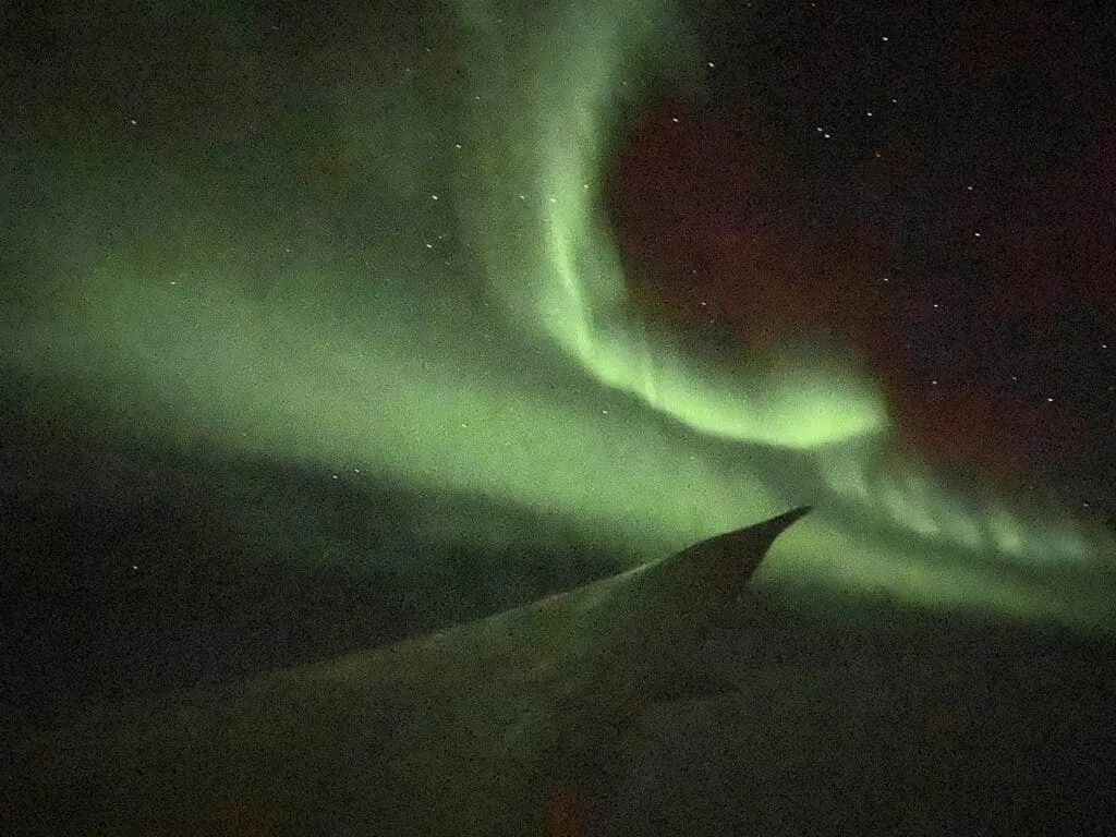 Southern lights over plane wing