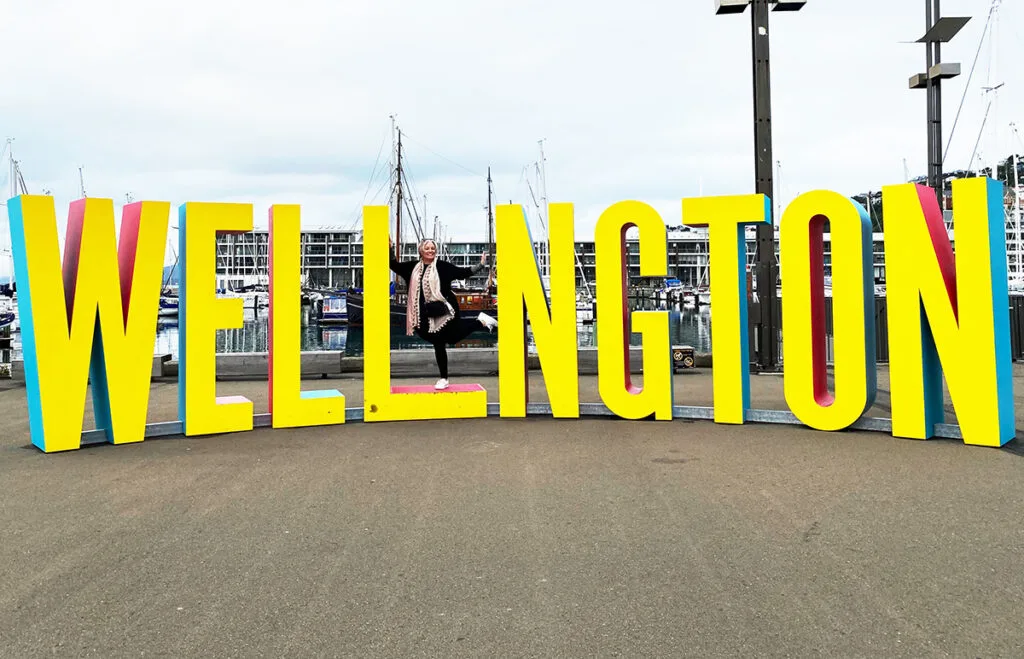 Megan standing on Wellington sign