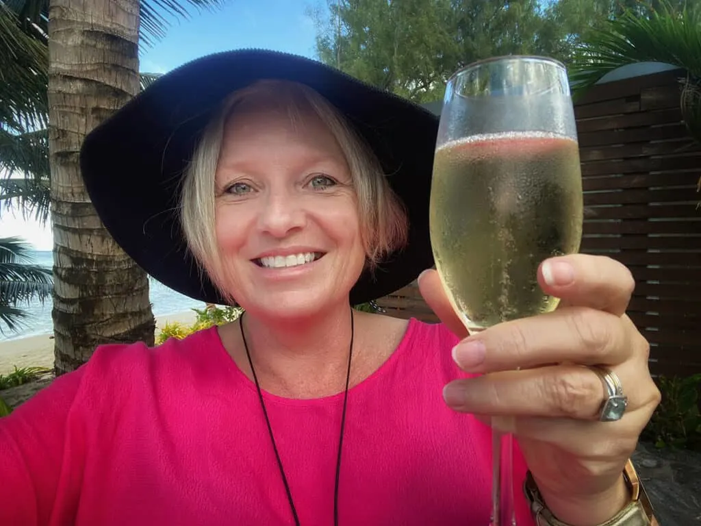 Megan toasting with champagne and straight hair