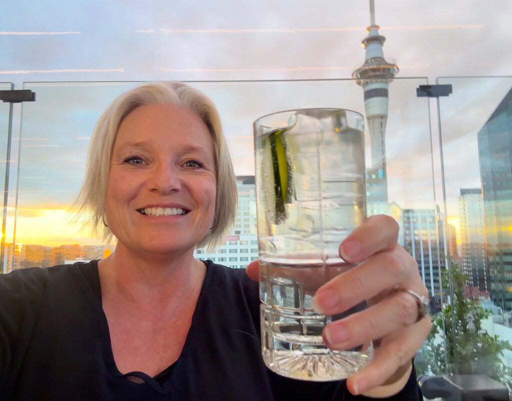 Megan at sunset with a gin at Aka Bar. Sky Tower behind