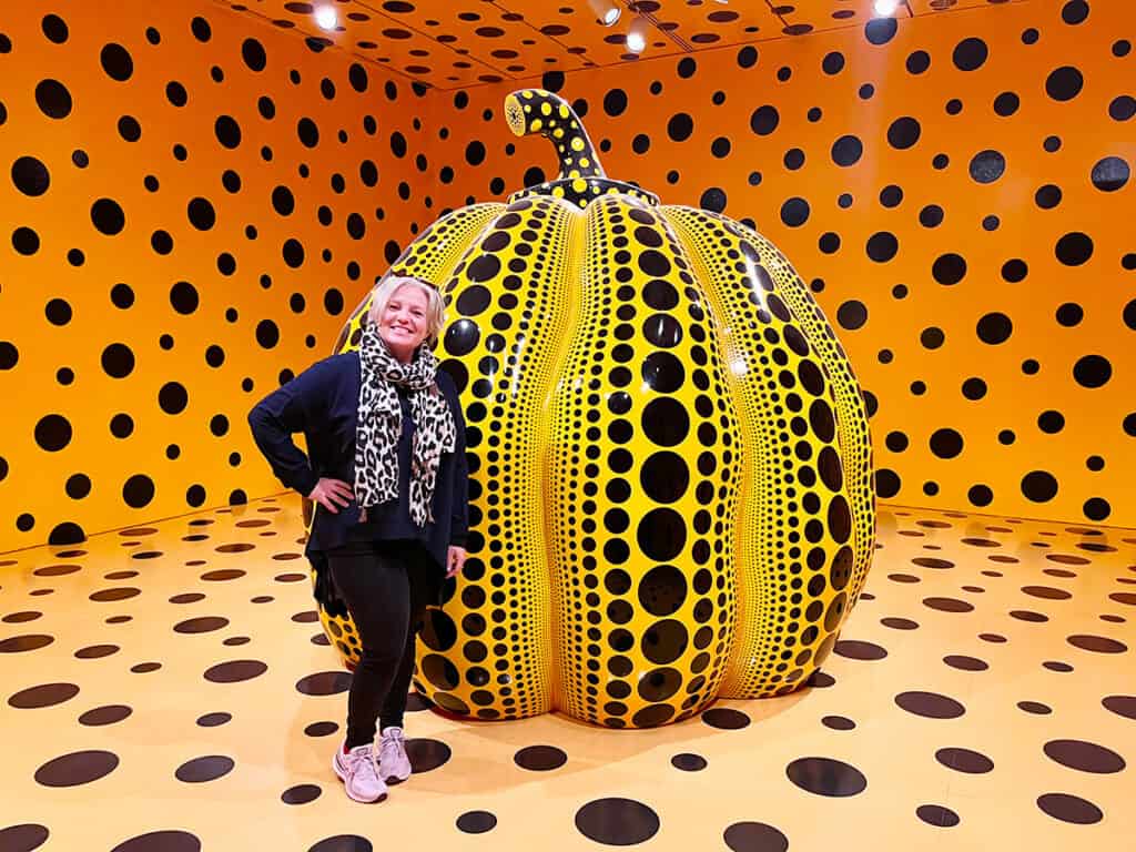 Standing beside Yayoi Kusama's famous pumpkin