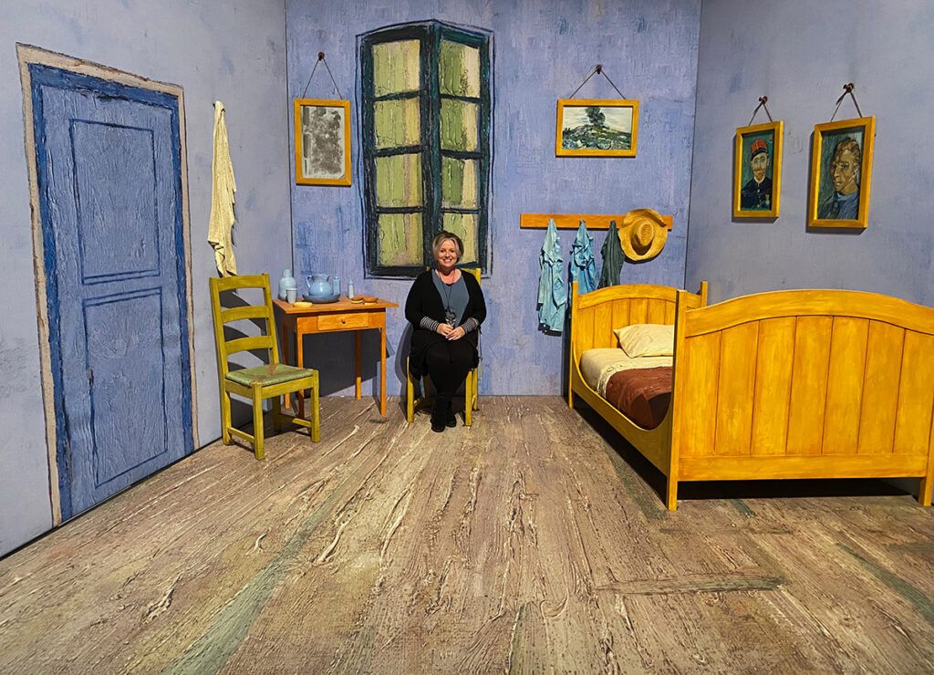 Megan sitting in Van Gogh bedroom scene