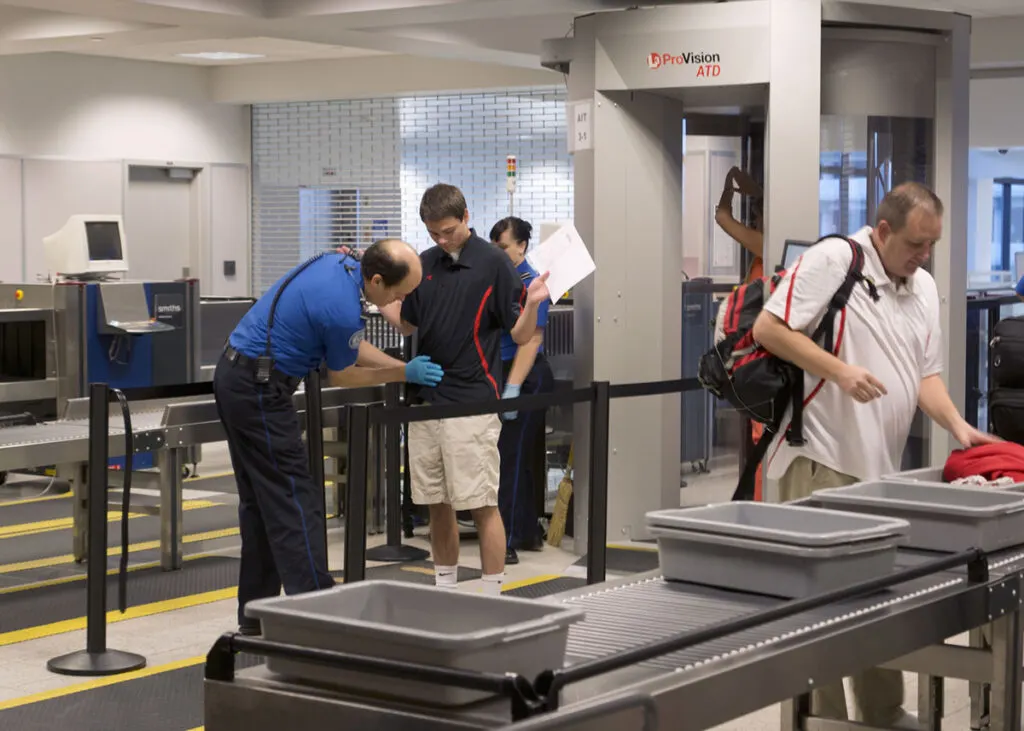 Passengers at airport security screening
