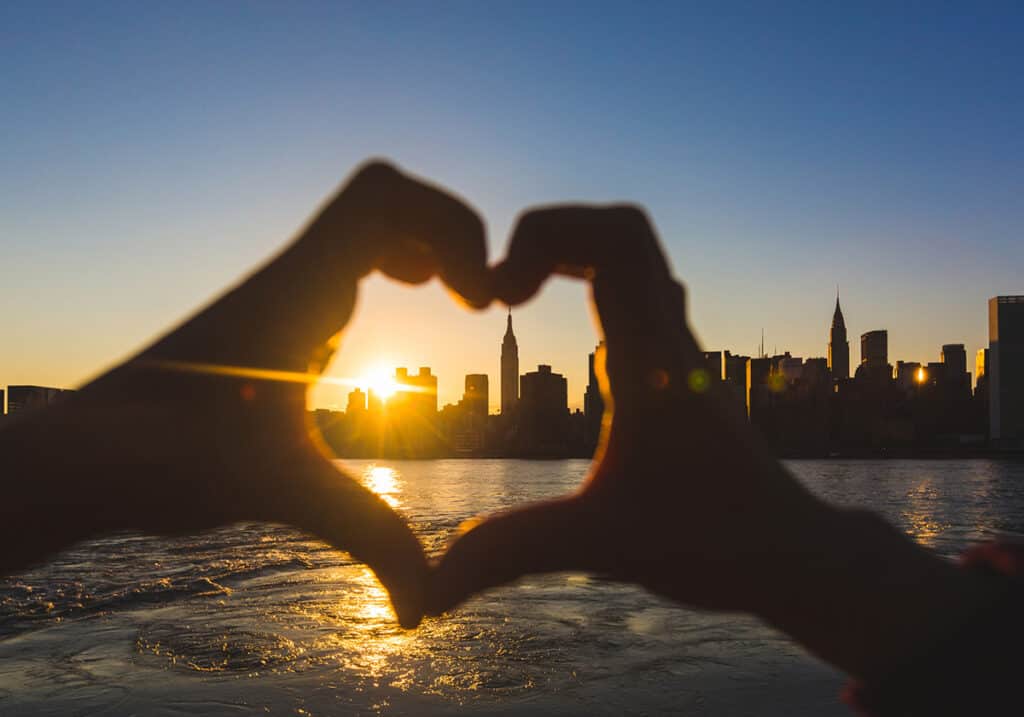 Love heart hands showing NYC skyline