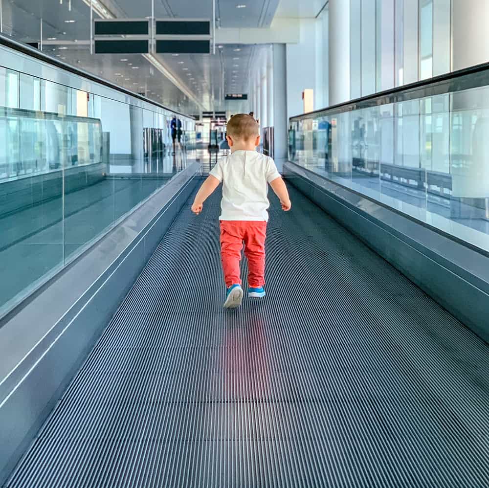 Child walking on airport travelator