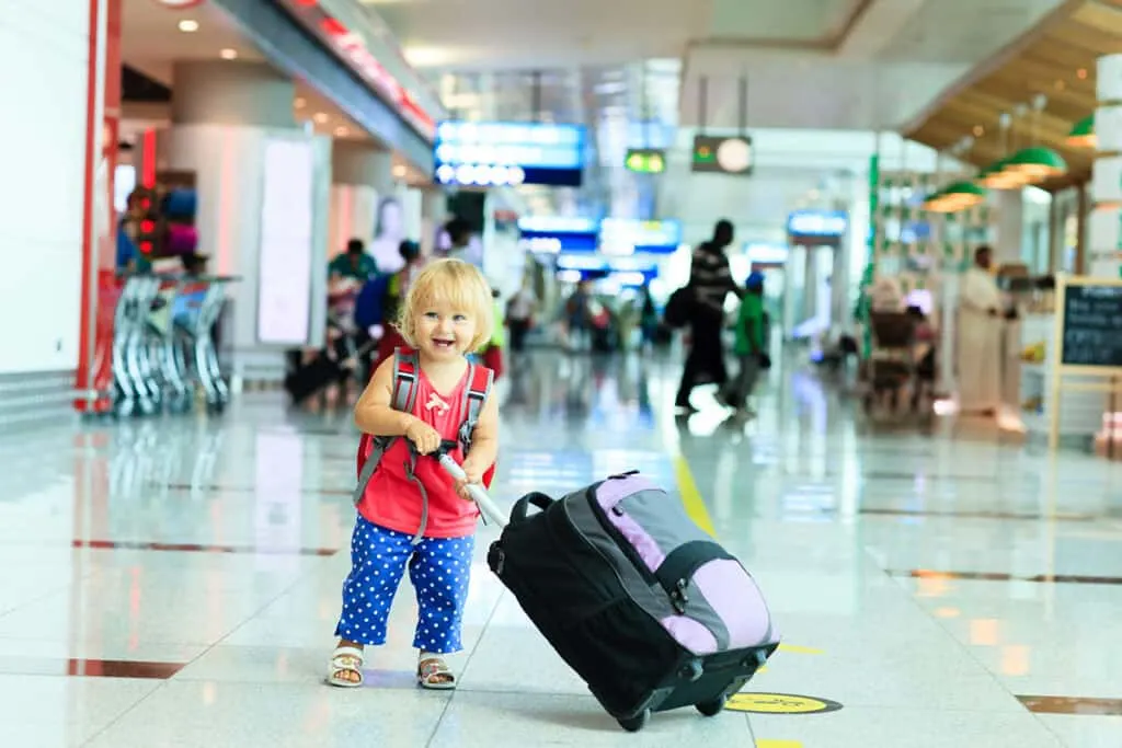Toddler with luggage at airport