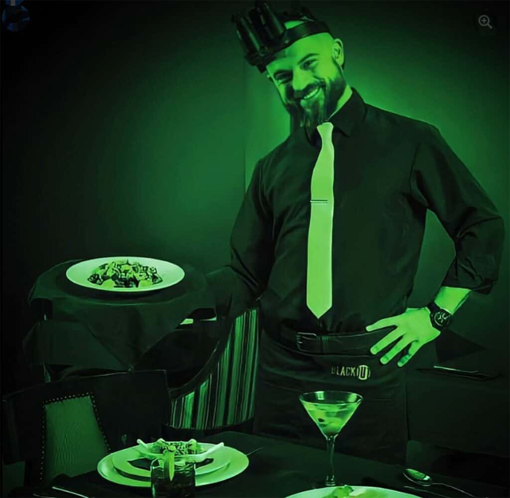 Waiter with plate at Dining in the Dark