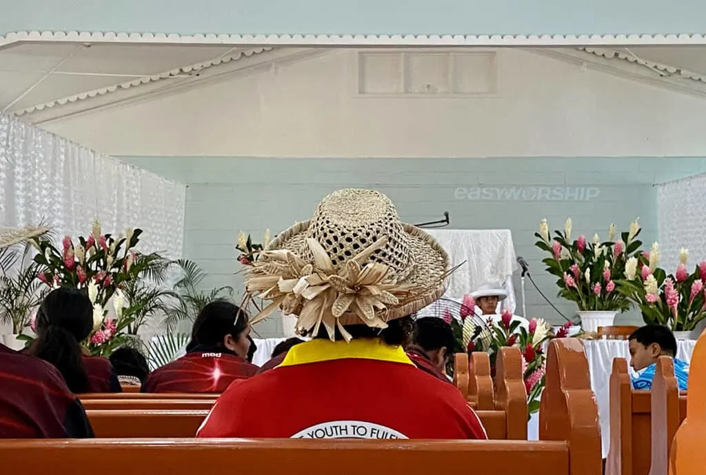 Lady in hat at church in Rarotonga