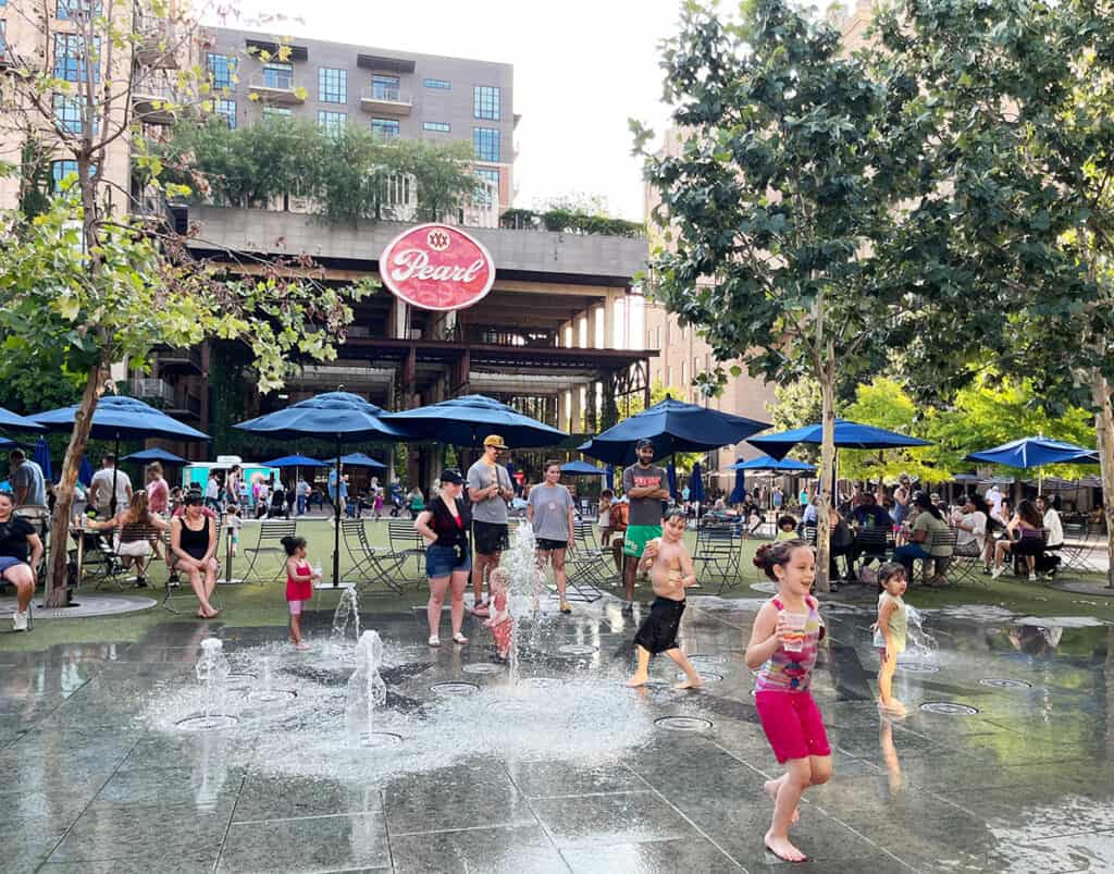 Kids in water fountains at The Pearl