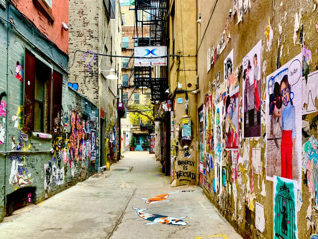 Narrow alley with street art on the walls in NYC