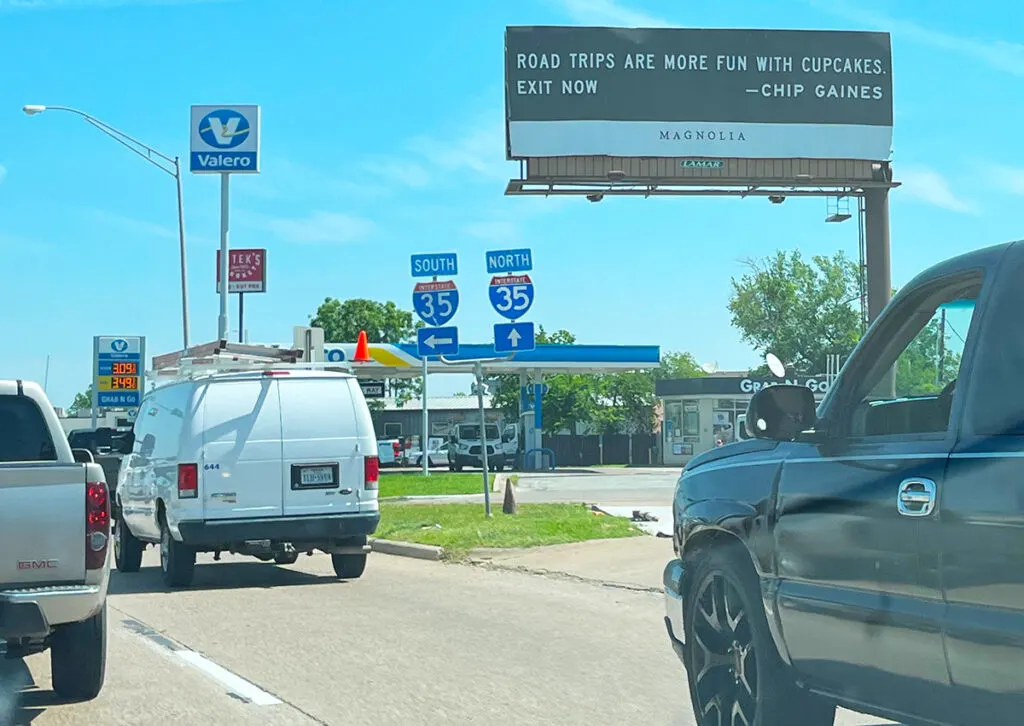 Road sign from Chip Gaines: "Road trips are more fun with cupcakes." Exit now