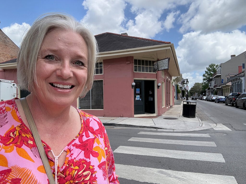Megan standing in front of New Orleans laundry Suds Dem Duds at 1101 Bourbon Street