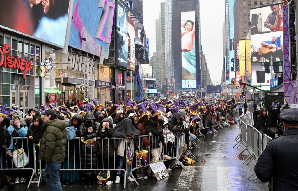 Crowds in Times Square waiting behind fences for ball drop