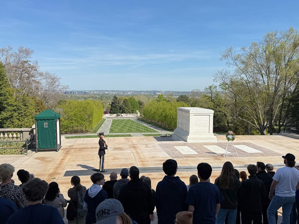 A guard stands to attention in front of the Tomb of the Unknown Soldier