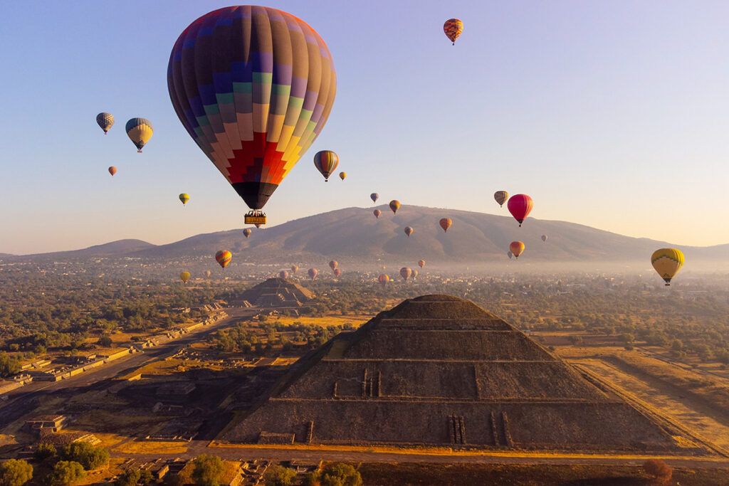Hot air ballooning over the Pyramids of Teotihuacan at dawn