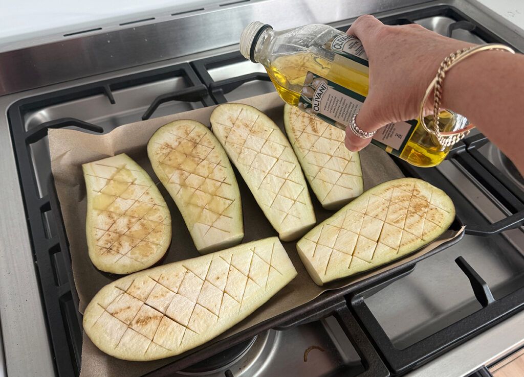 pouring oil on eggplants