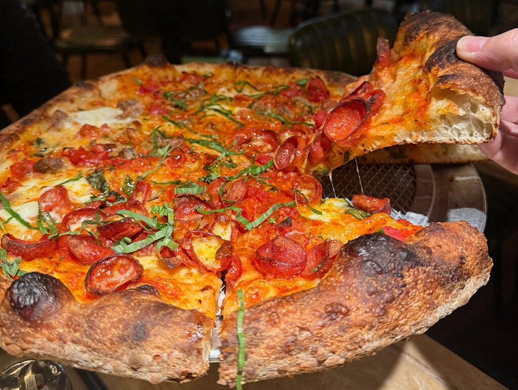 Megan's margherita pizza slice at Robert's