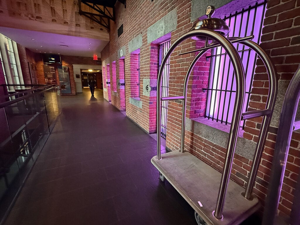 The Liberty Hotel hallway to the elevators where lights showcase the jail cells