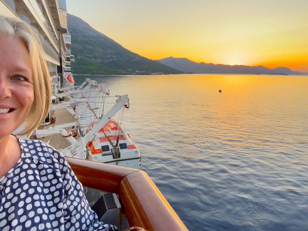 Megan on balcony of accessible cabin at sunrise