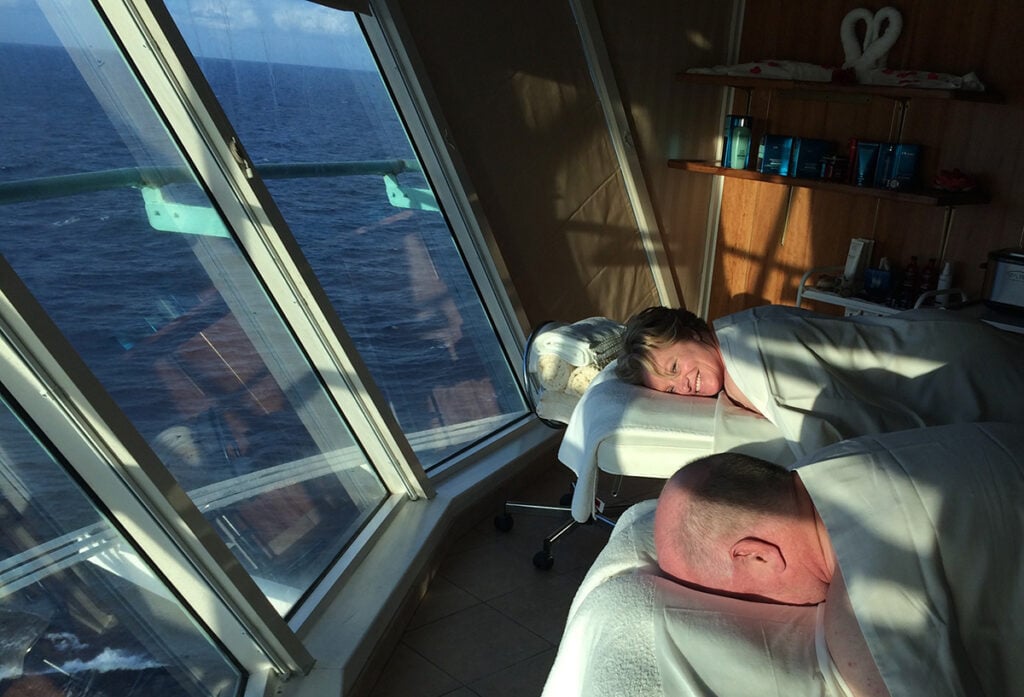 Megan and husband in couple's massage with ocean views