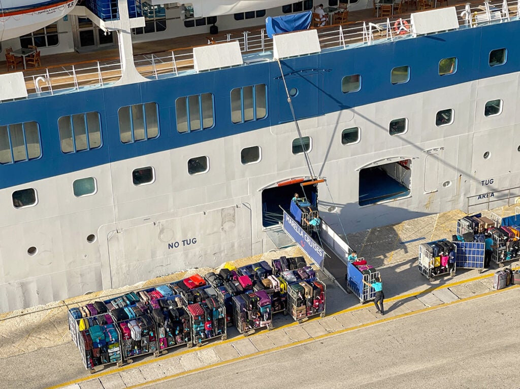cruise luggage waiting to be loaded from the dock