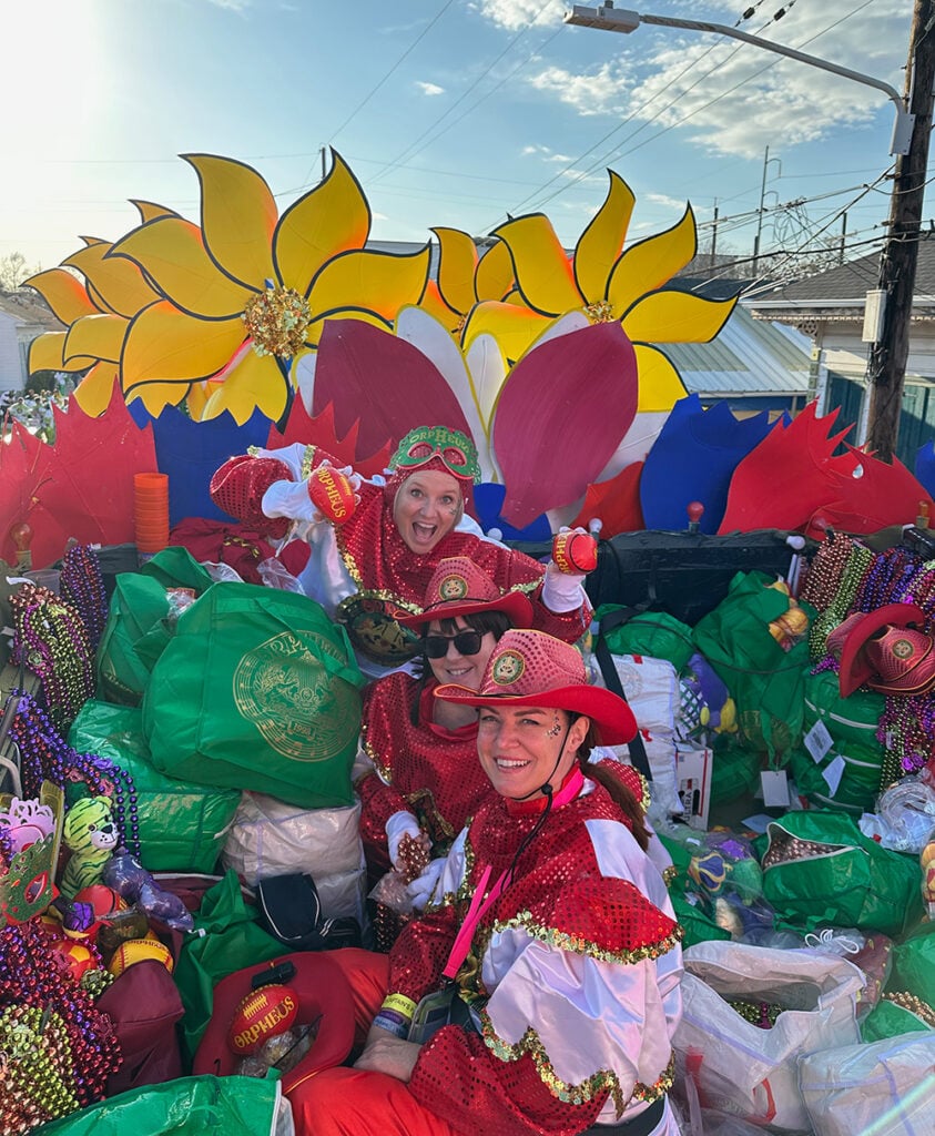 Megan and friends lost amongst the toys and beads, waiting on Tchoupitoulas to start rolling