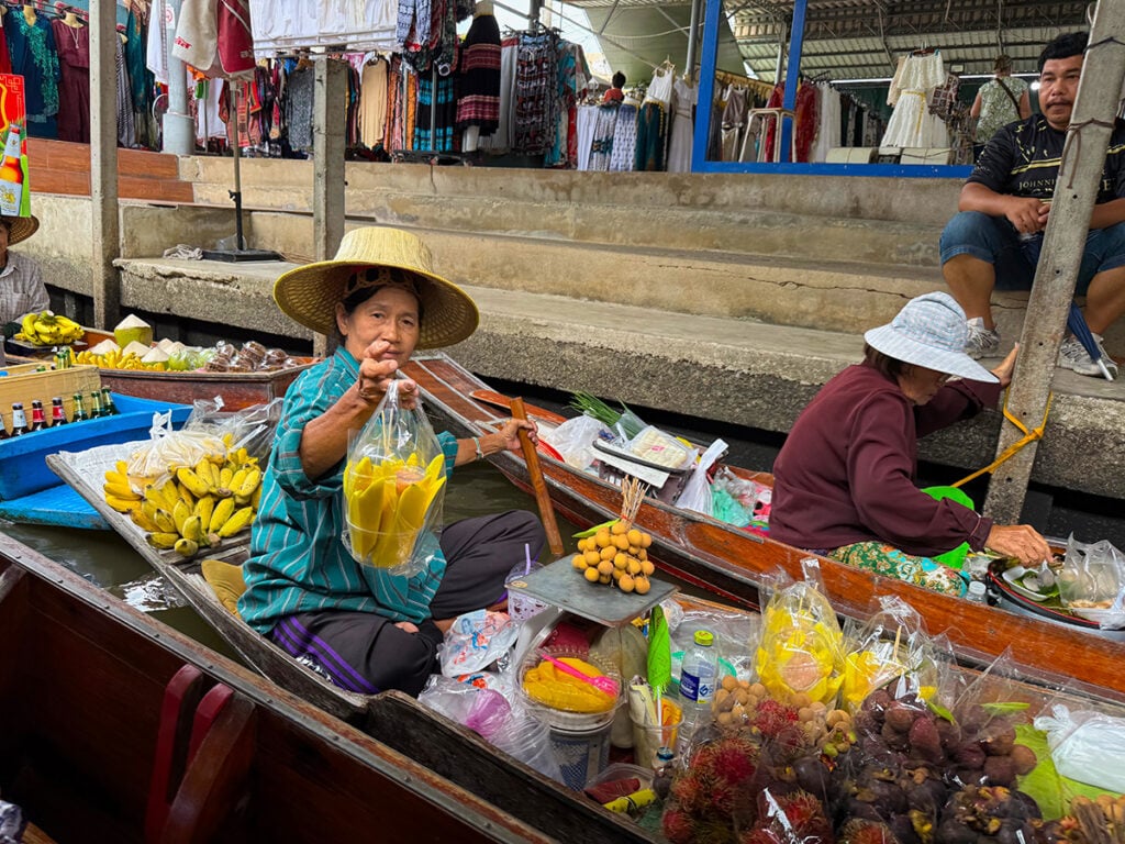 Vendor offering mango for sale at the Floating Market