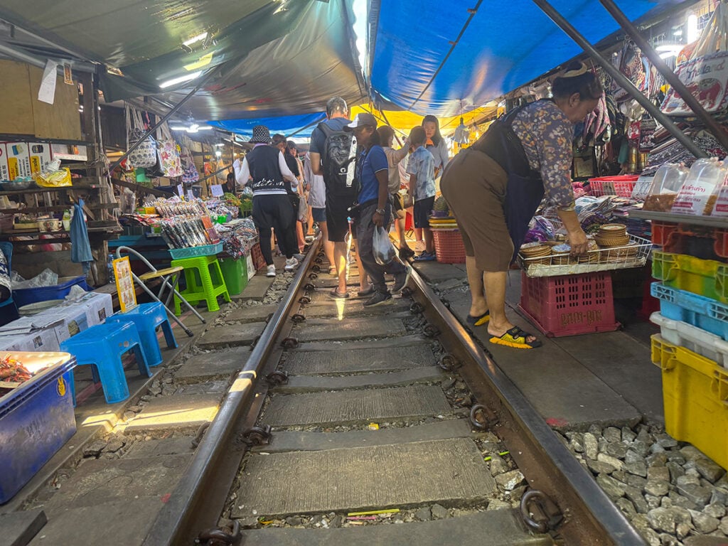 Vendors move their wares before folding their awnings down