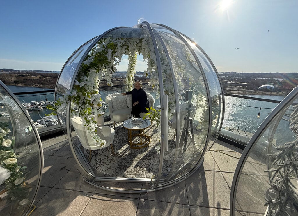 Megan in igloo on La View rooftop at The Wharf