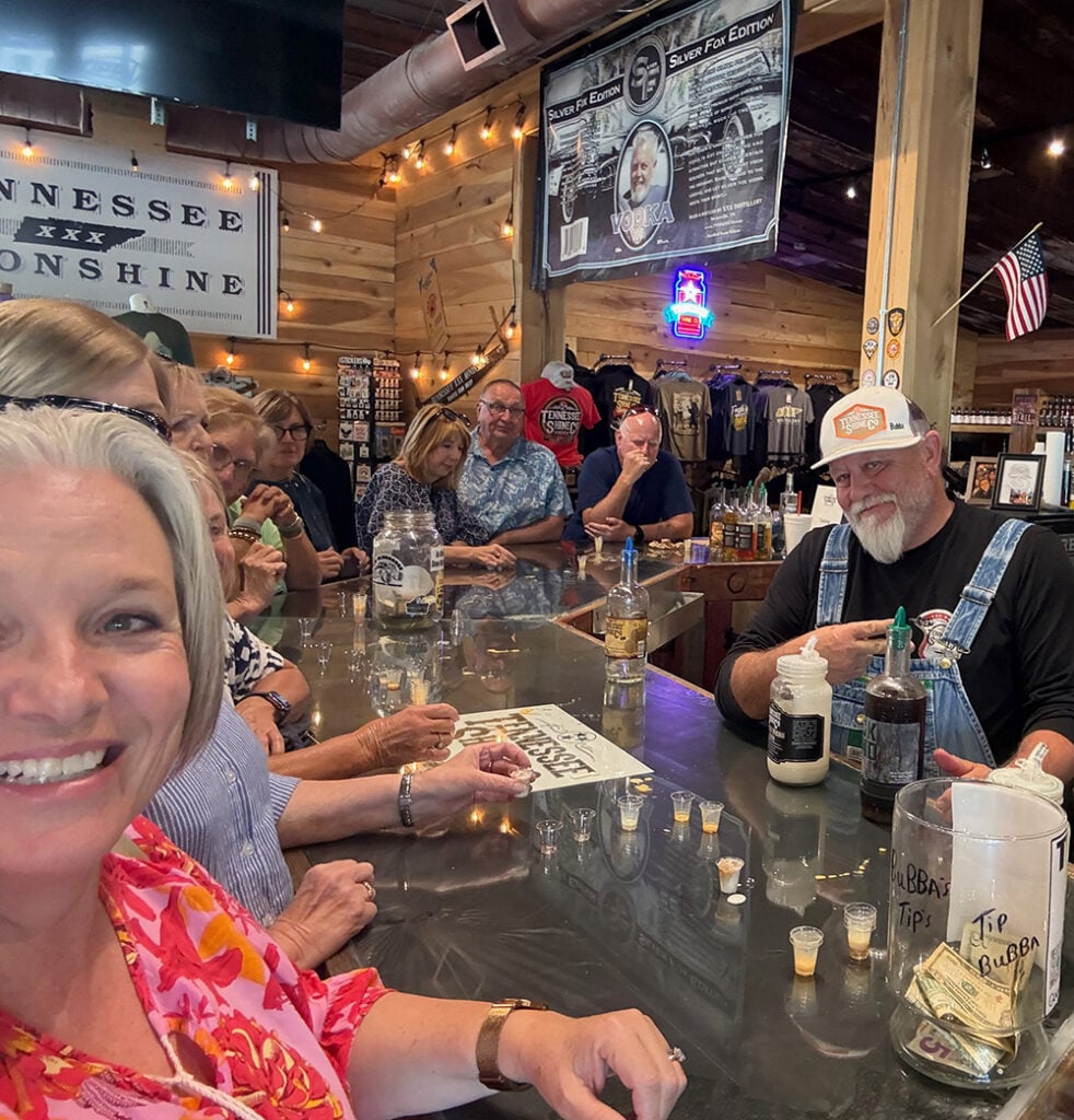 Bubba poured out little thimbles of his moonshine