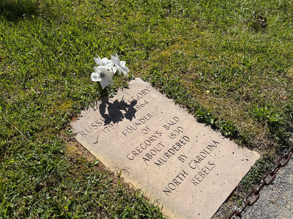 Gravestone at Cades Cove Primitive Baptist reads Russell Gregory, 1795-1864. Murderd by North Carolina Rebels