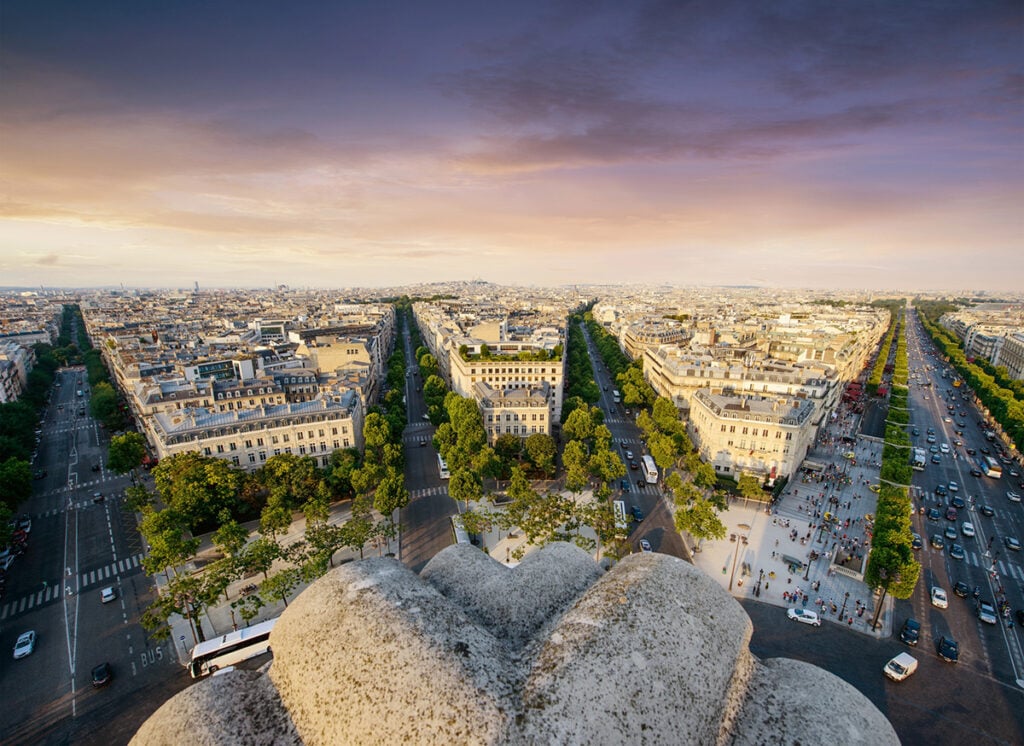 Standing on top of the Arc de Triomphe looking over the streets of Paris