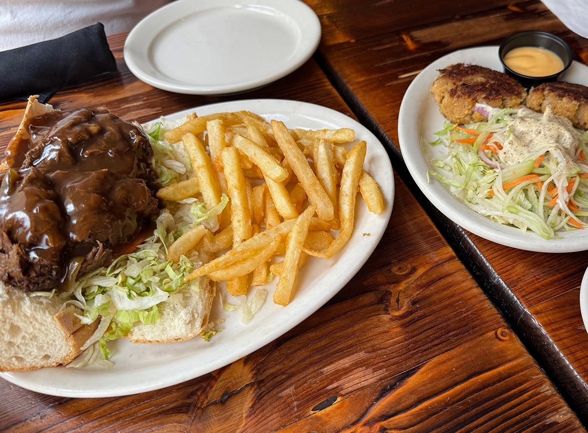 Our plates of brisket po boy and crab cakes