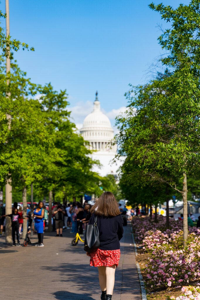 Woman walking towards Capitol Building during DC State Fair
